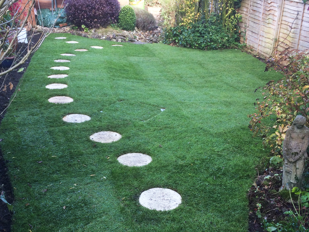 The finished lawn, complete with new stepping stones, looks amazing.