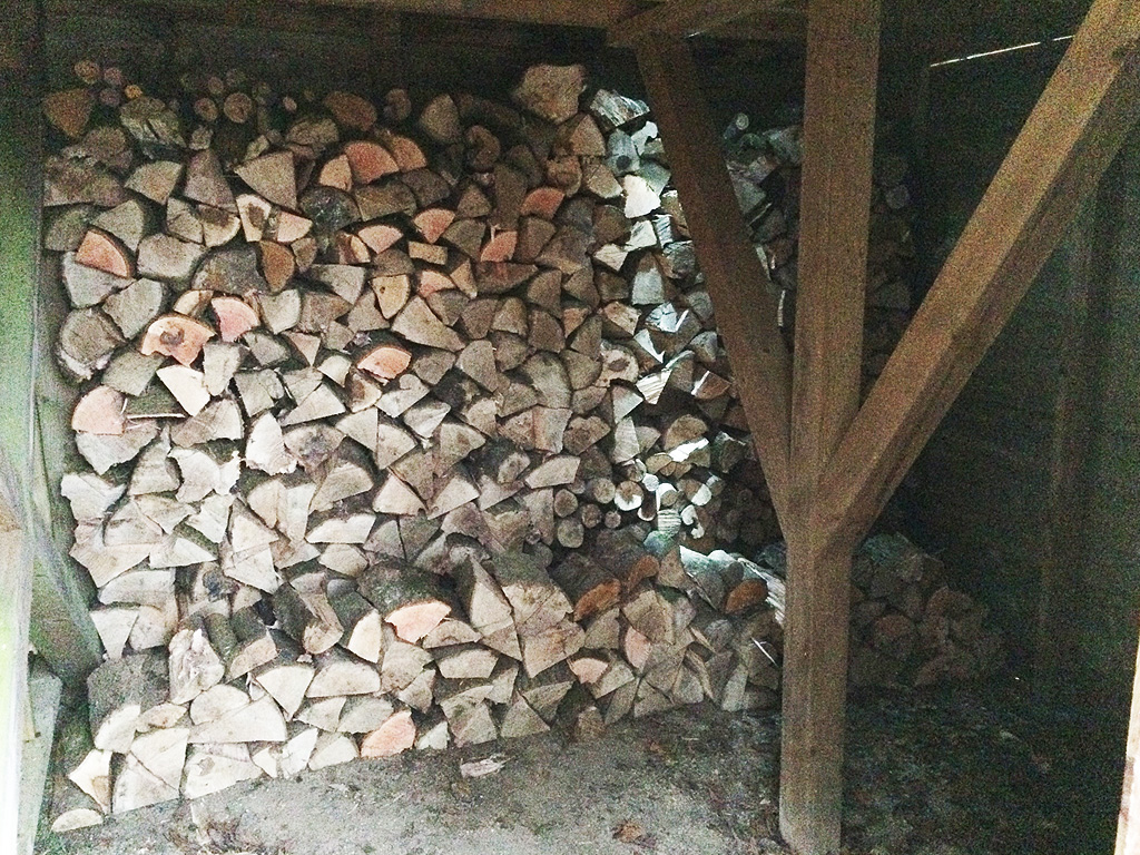 Loads of log storage for seasoning firewood.
